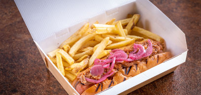 Pulled Pork Dog with chips in a takeaway box