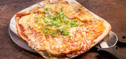 Cheddar, Mozzarella, tomato sauce and rocket served on a pizza plate