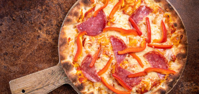 Pepperoni, with Bell peppers, Cheddar, Mozzarella, tomato sauce and rocket  served on a pizza plate