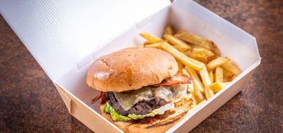 Burger with chips in a takeaway box